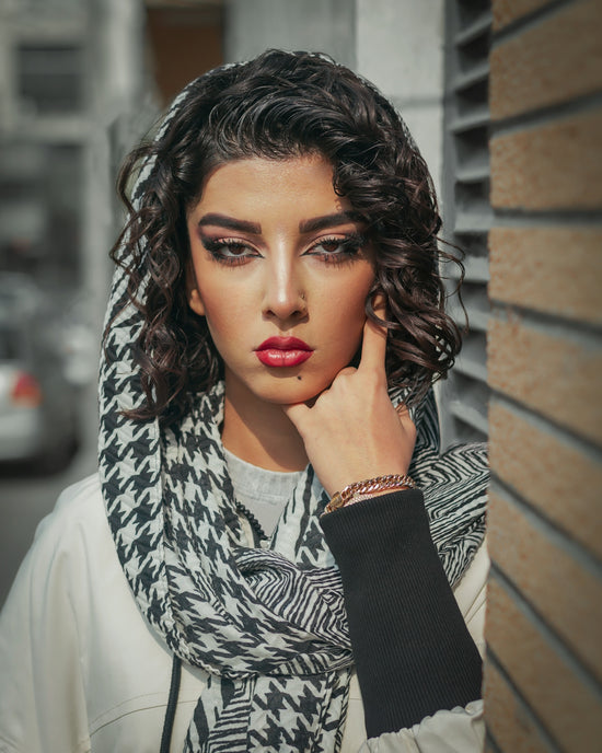 a woman with her hand on her face