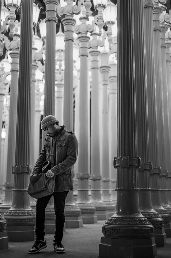 a man standing in front of a large chandelier
