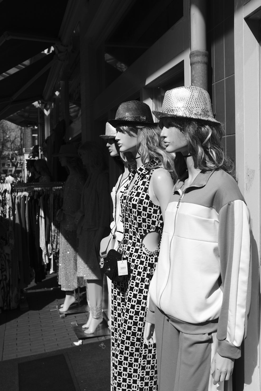Mannequins in hats and dresses displayed outside store